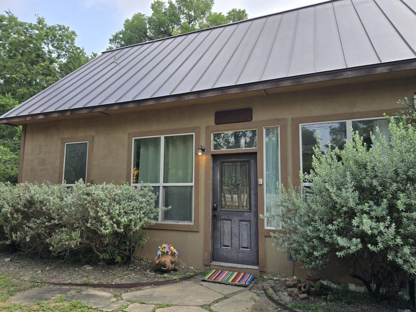 A house with a metal roof and a door.