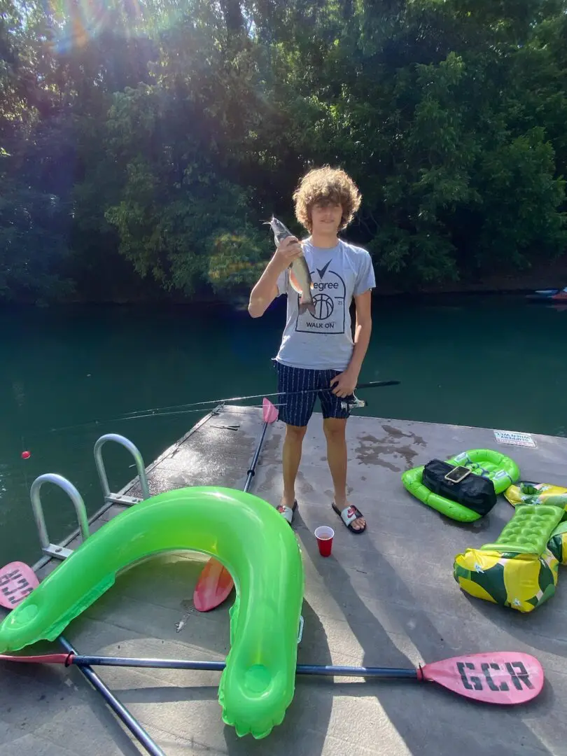 A man standing on the side of a boat.