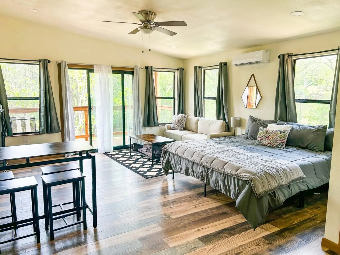 A bedroom with a bed, table and chairs.