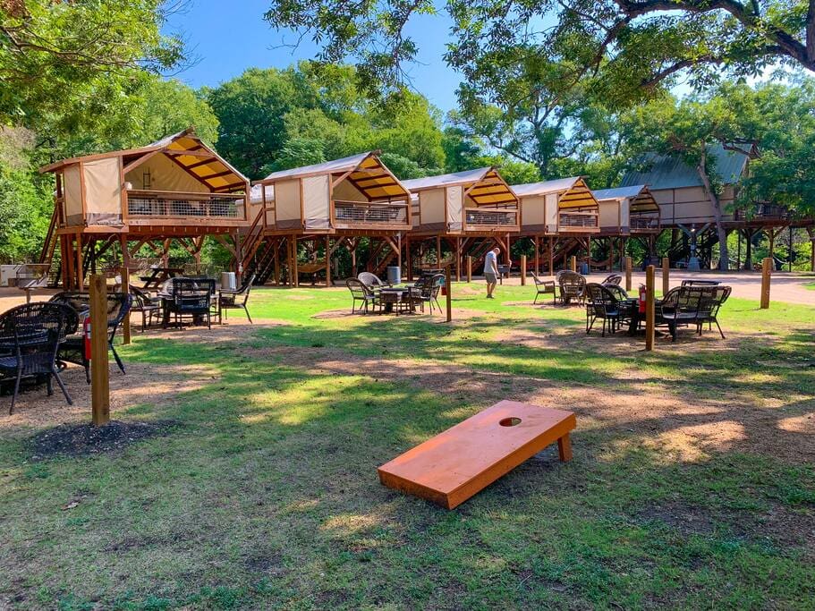 A lawn with several tables and chairs in it.