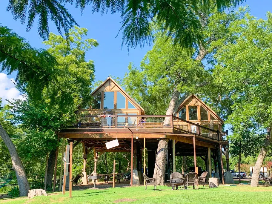 A large wooden structure sitting in the middle of a field.